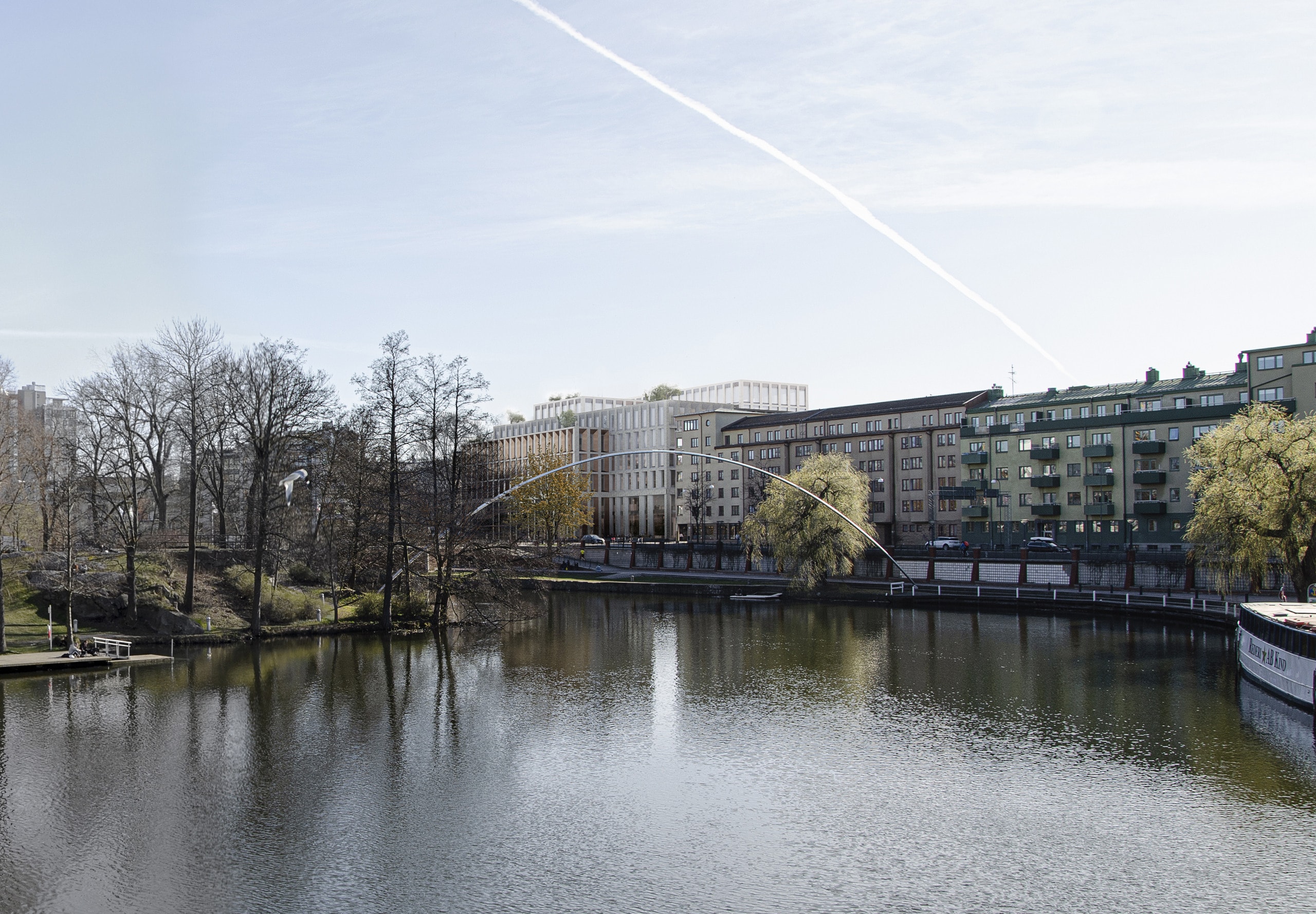 Å i förgrunden och så sticker den nya fastigheten upp vid kanten av ån.