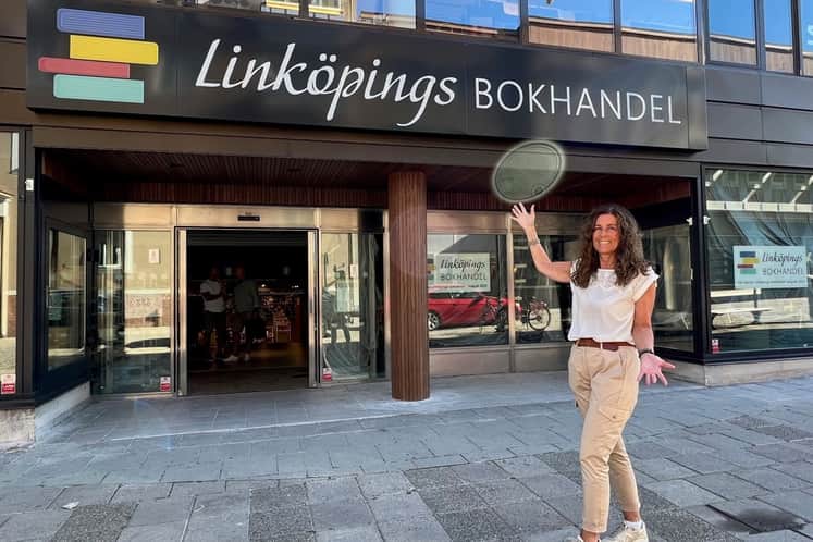 Kvinna står framför ingång till bokhandel