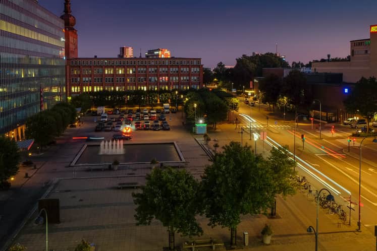 Stadsvy över torg och gata.